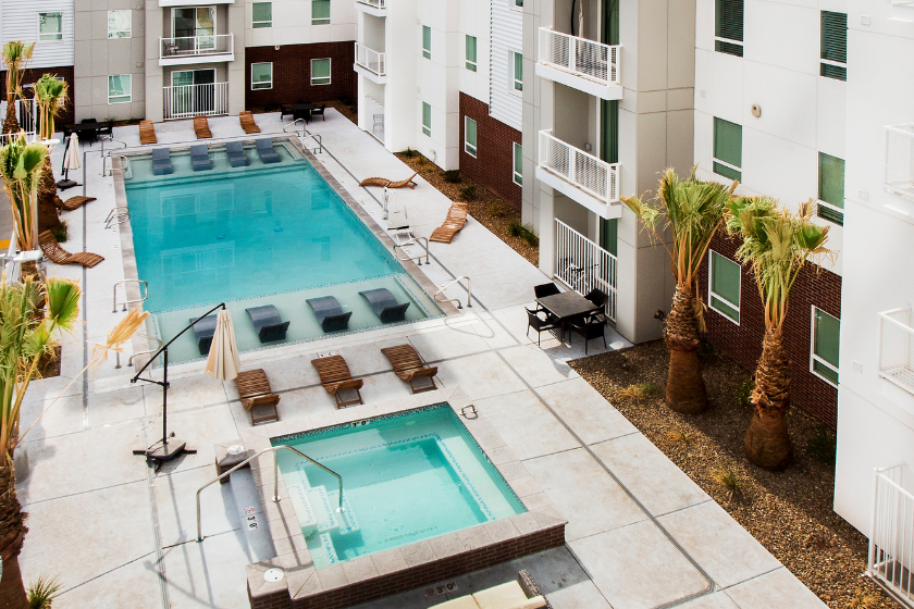 Private resort-style pool and hot tub with lounge areas at 605 Place student housing in St. George.
