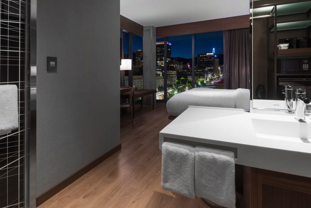 A master suite with a view of SLC at night in the AC Hotel in Salt Lake City