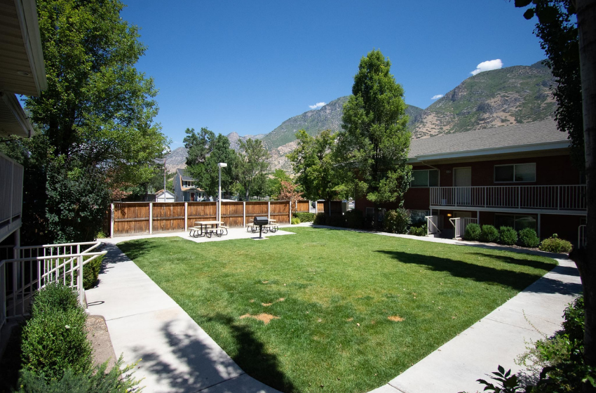 Communal greenspace and barbeque area at a Hallady Living apartment complex in Orem and Provo.
