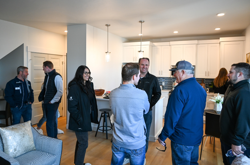 Visitors touring an Alante Home at Lake Hazel during the grand opening, exploring its interior features and design